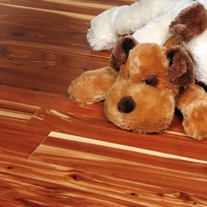 A stuffed toy dog lying on a red and cream streaked cedar floor